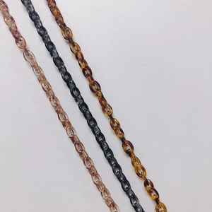 Detail of amber and black resin oval link chains for DIY jewelry making and bag straps