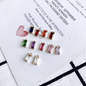 Set of colorful rectangular crystal charms with gold-plated geometric copper settings