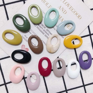Detailed macro view of smooth colorful resin oval rings for DIY earring and jewelry making