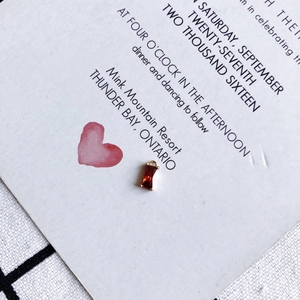 Detail of a red rectangular zircon pendant in a gold-plated setting for DIY jewelry