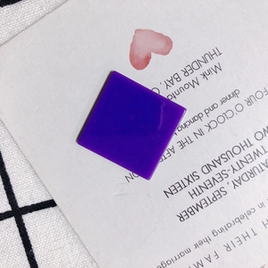 Flat lay of square deep purple acrylic resin charms for DIY jewelry making accessories