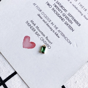 Macro detail of rectangle emerald green zircon pendant with gold plated copper setting