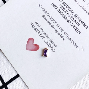 Macro shot of rectangular purple zircon pendant with gold plated edges and top jump ring