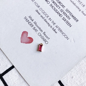 Macro shot of a rectangular pink crystal pendant with gold plating and four-prong setting