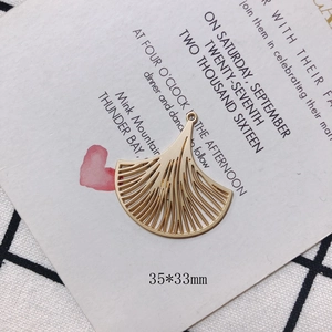 Macro detail of a 35x33mm fan-shaped gold ginkgo leaf pendant for DIY jewelry making