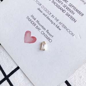 Detailed macro view of a gold square zircon pendant with an elegant rectangular gemstone