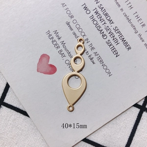 Close-up of matte gold geometric drop charms with 40x15mm size markings for DIY jewelry