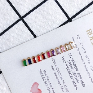 Detail of multi-colored rectangular crystal pendants with gold loops for DIY jewelry