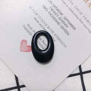 Close-up of a polished black oval resin pendant accessory for DIY earring making