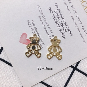 Detailed view of 27x18mm golden hollow bear charms with B-letter engraving for DIY jewelry