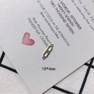 Macro detail of a 18x4mm golden metal rectangle charm connector with double loop hooks