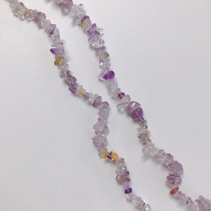 Detailed view of DIY translucent purple and amber irregular geometric stone necklace beads