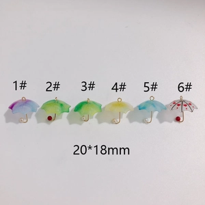 Detailed view of assorted 20x18mm resin umbrella pendants with colorful designs