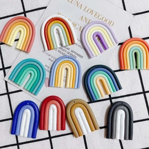 Flat lay of colorful rainbow resin charms for DIY jewelry making in 10 diverse palettes