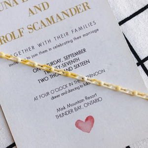 Detailed view of yellow and white marbled acrylic rectangle chain links for DIY jewelry