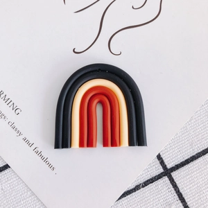 Macro view of a colorful rainbow clay pendant charm for DIY jewelry making accessories
