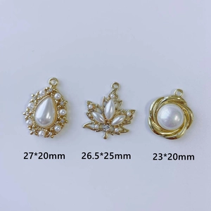 Detailed view of DIY earring charms with pearls and rhinestones in three sizes