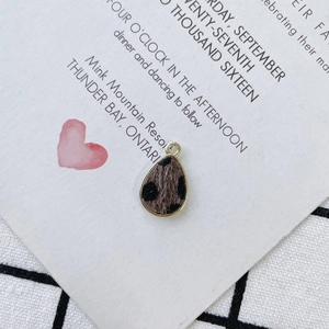 Detail of leopard print teardrop pendant with gold metal trim for DIY jewelry making