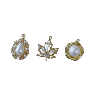 Elegant gold-plated pearl pendants in teardrop, maple leaf, and round spiral designs