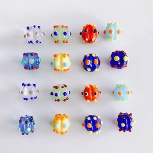 Macro detail of handmade colorful polka dot glass beads for DIY jewelry making and pendants