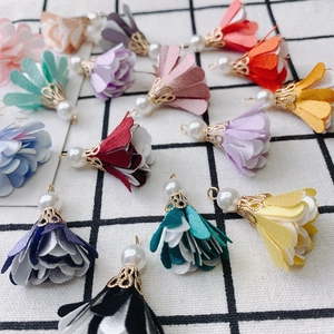 Macro detail of multi-color fabric flower charms with pearls for DIY jewelry making