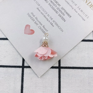 Detail of DIY floral fabric charm with white faux pearl and golden metal cap