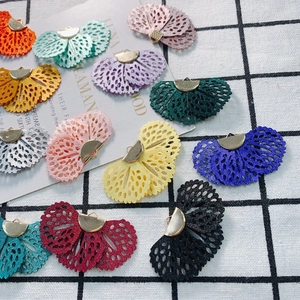 Macro view of multi-colored fan-shaped lace pendants with metal clips for DIY jewelry