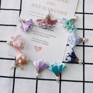 Detail of colorful fabric flower tassels with metal base and pearl for DIY earrings