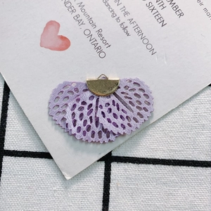 Detailed macro of vintage purple lace fan pendant with golden metal loop for DIY jewelry
