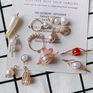 Detailed view of handmade gold wire-wrapped pearl charms for DIY jewelry making