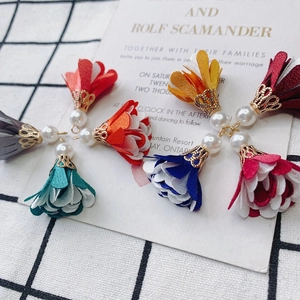 Macro shot of colorful fabric flower tassels with pearls for DIY jewelry making