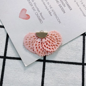 Close-up of pink lace fabric flower pendant with gold metal clasp for DIY accessories