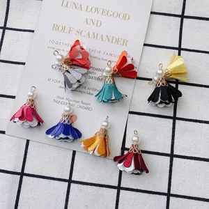 Detail of DIY multilayer fabric flower pendants with pearls and golden caps for jewelry making