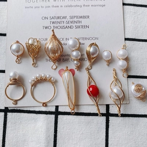 Detailed view of handmade copper wire wrapped pearl pendants for DIY jewelry making