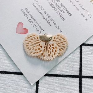 Detailed close-up of apricot embroidery lace fan pendant with golden metal top for DIY jewelry