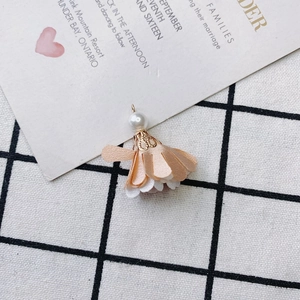 Detail of fabric flower pendant with champagne petals and imitation pearl bead decoration