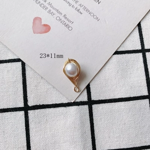 Detail of 23x11mm pearl pendant with gold copper wire wrap in a delicate leaf shape