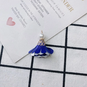 Close-up of DIY floral fabric tassel pendant with white imitation pearls and gold cap