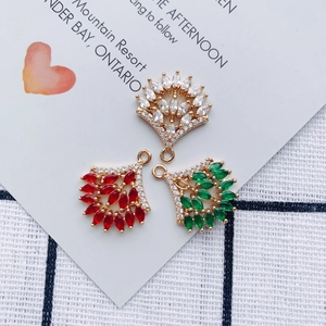 Macro shot of fan-shaped alloy pendants with inlaid colorful crystals and small diamonds