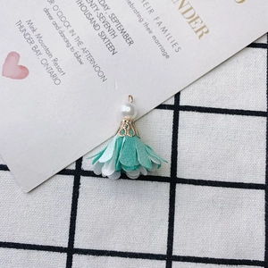 Detail of DIY floral fabric tassel pendant with imitation pearl and gold cap decoration