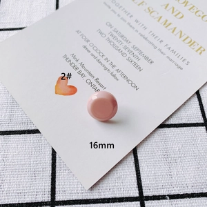 Detailed view of a 16mm pink acrylic portrait relief pendant with a smooth convex surface