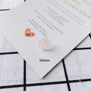Macro shot of 14mm light pink translucent DIY resin button with two holes and number 3