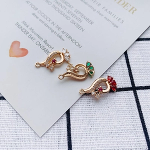 Detail of peacock alloy pendants with colorful stones and rhinestones for DIY jewelry