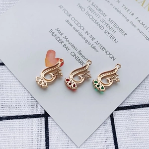 Detailed macro view of DIY alloy peacock charms with sparkling rhinestones and colorful gems