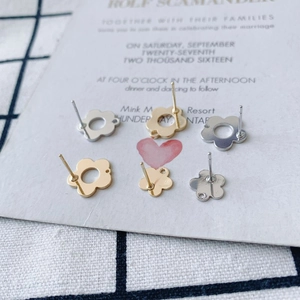 Macro shot of geometric flower hollow earrings in gold and silver for DIY jewelry