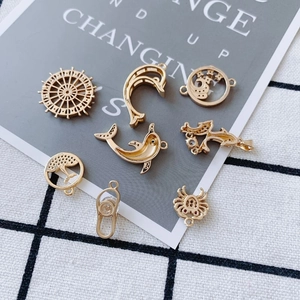 Gold-plated ocean theme pendants including dolphin and crab shapes for DIY jewelry making