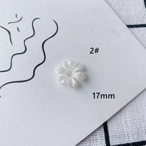 Close-up of 17mm pearlescent white acrylic flower charm for DIY jewelry making
