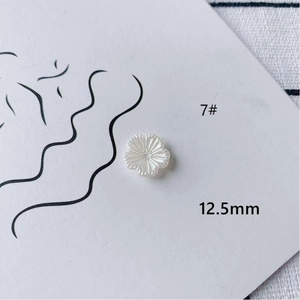 Detail view of 12.5mm white acrylic rose flower charms for DIY jewelry making