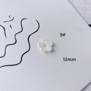 Macro detail of 12mm white acrylic five-petal flower bead for DIY jewelry making