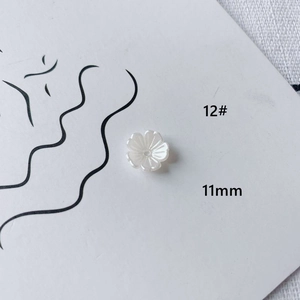 Detail showing 11mm pearl white flower acrylic bead with petal texture and center hole